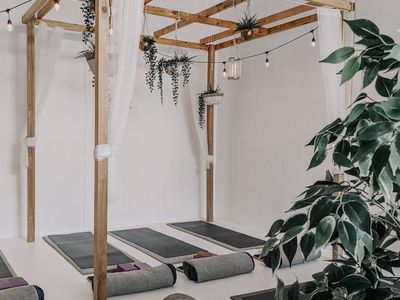 A peaceful yoga studio interior with soft sunlight