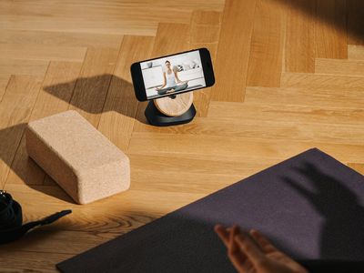 Yoga blocks and a rolled mat on a wooden floor